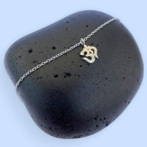 Spiritual anklet with a silver ohm symbol charm.
