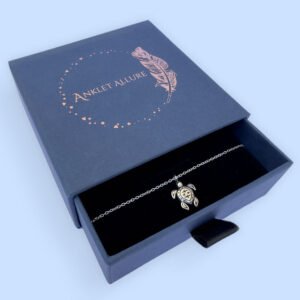 Tranquil anklet with a charm of a cute silver turtle, presented in a blue jewellery box with Anklet Allure written on the top in rose gold.