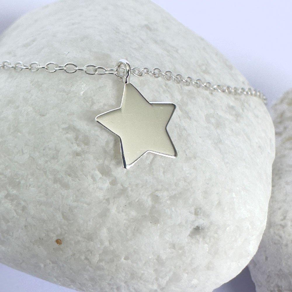 A17-Anklet-white-rock-(1) Close up of shiny bright anklet with solid silver star charm.