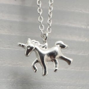 Close up of sterling silver anklet with unicorn charm.