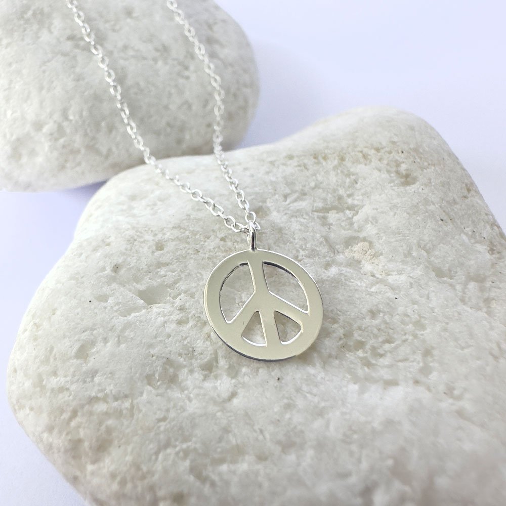 A19-Anklet-white-rock-(2) Peace symbol charm on a silver anklet.