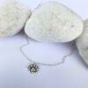 Silver anklet with a charm of a pawprint with ionised silver detail.