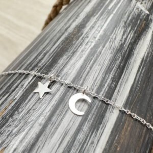Sterling silver ankle bracelet with a dainty star and crescent moon charm.