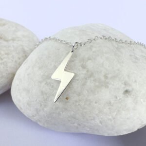 Powerful silver anklet with a charm of a lightening bolt.