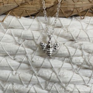 Sterling silver bee charm on a silver ankle bracelet.