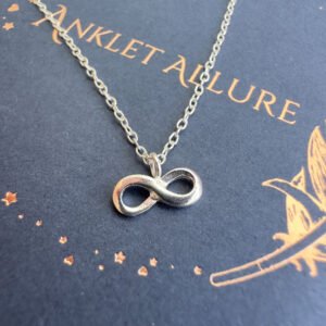 Infinity silver charm on anklet.