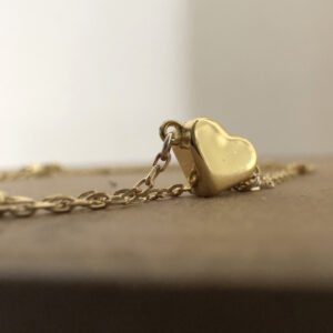 Meaningful solid gold love heart on a simple gold ankle bracelet.