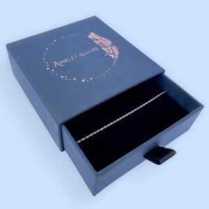 Plain silver ankle bracelet presented in a dark blue Anklet Allure gift box.