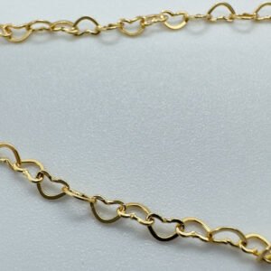 Close up of Identical gold hearts interlinked to make a dainty anklet.