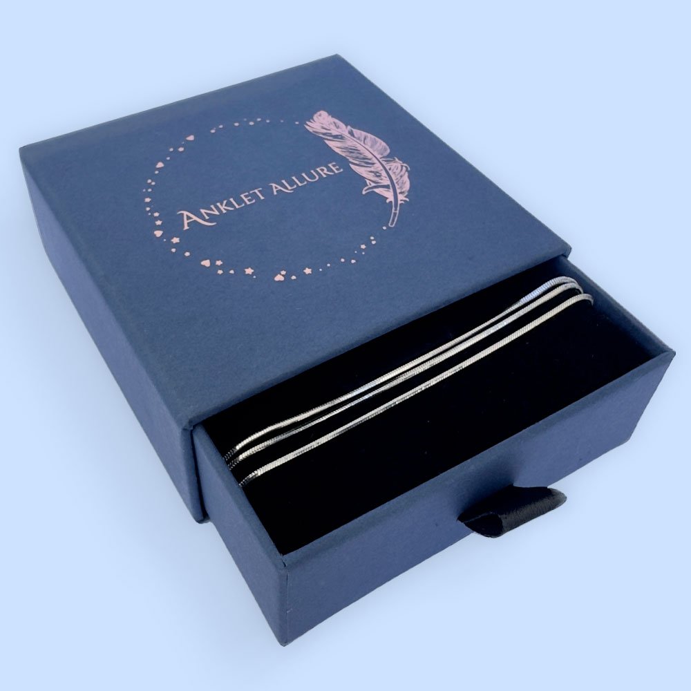 D1-Anklet-box Triple chain silver anklet in a blue jewellery box.