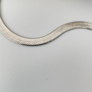 Close up of a thick silver snake chain anklet.