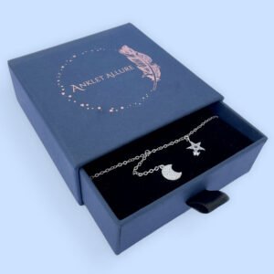 Ankle bracelet with a five pointed star and a crescent moon, both diamond encrusted, presented in a blue box.