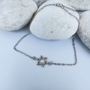 Silver anklet with a star of David charm on white rocks.