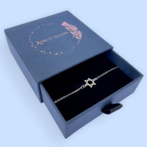 Silver anklet with a star of David charm in a blue jewellery box.