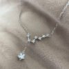 Seven smaller cubic zirconia gems linked together in a pattern similar to the big dipper star formation, with a larger gemstone as the main feature hanging lower from the silver ankle bracelet.