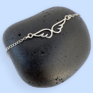 Beautiful silver anklet with an angel's wings sitting in the chain.